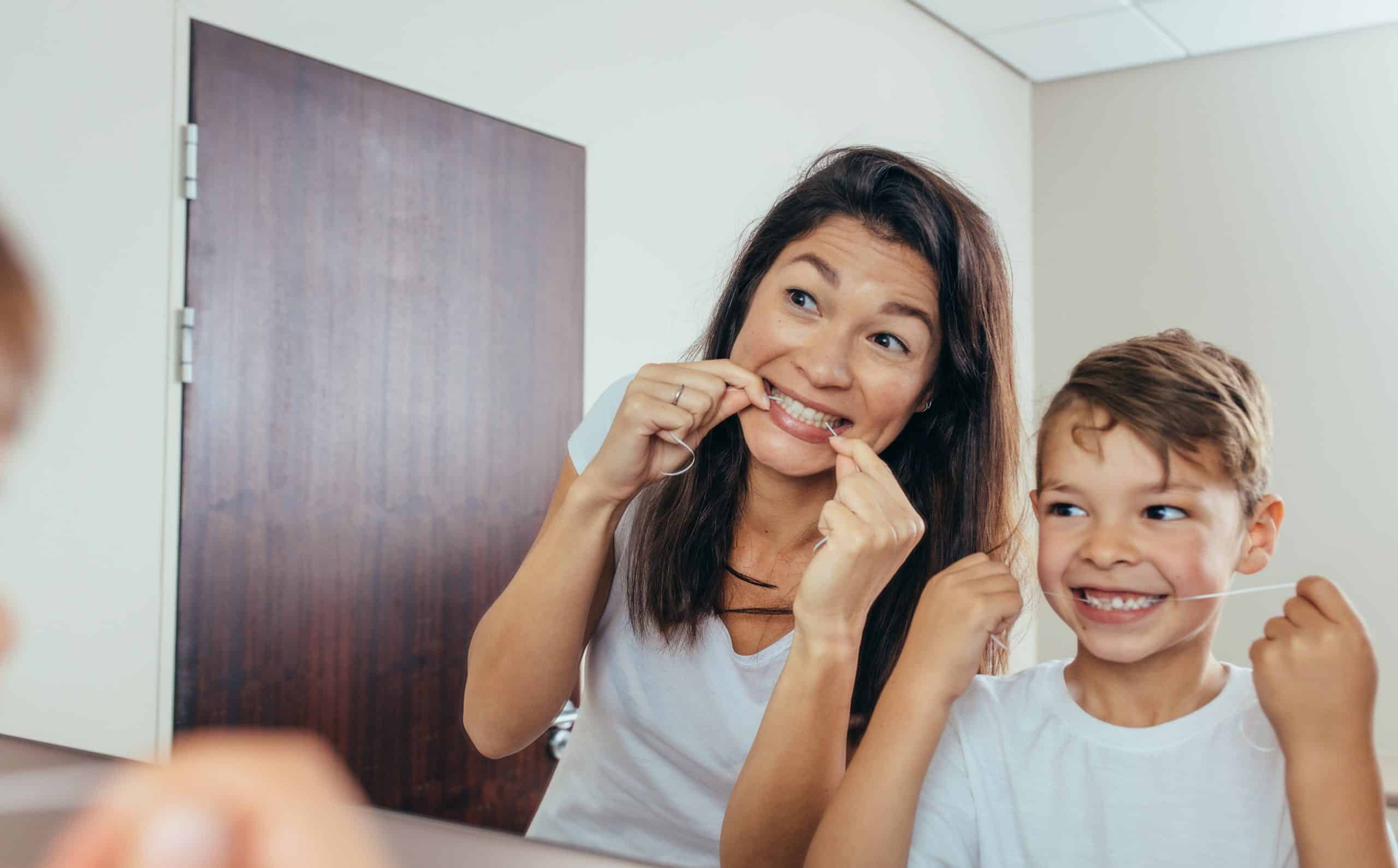 family flossing teeth