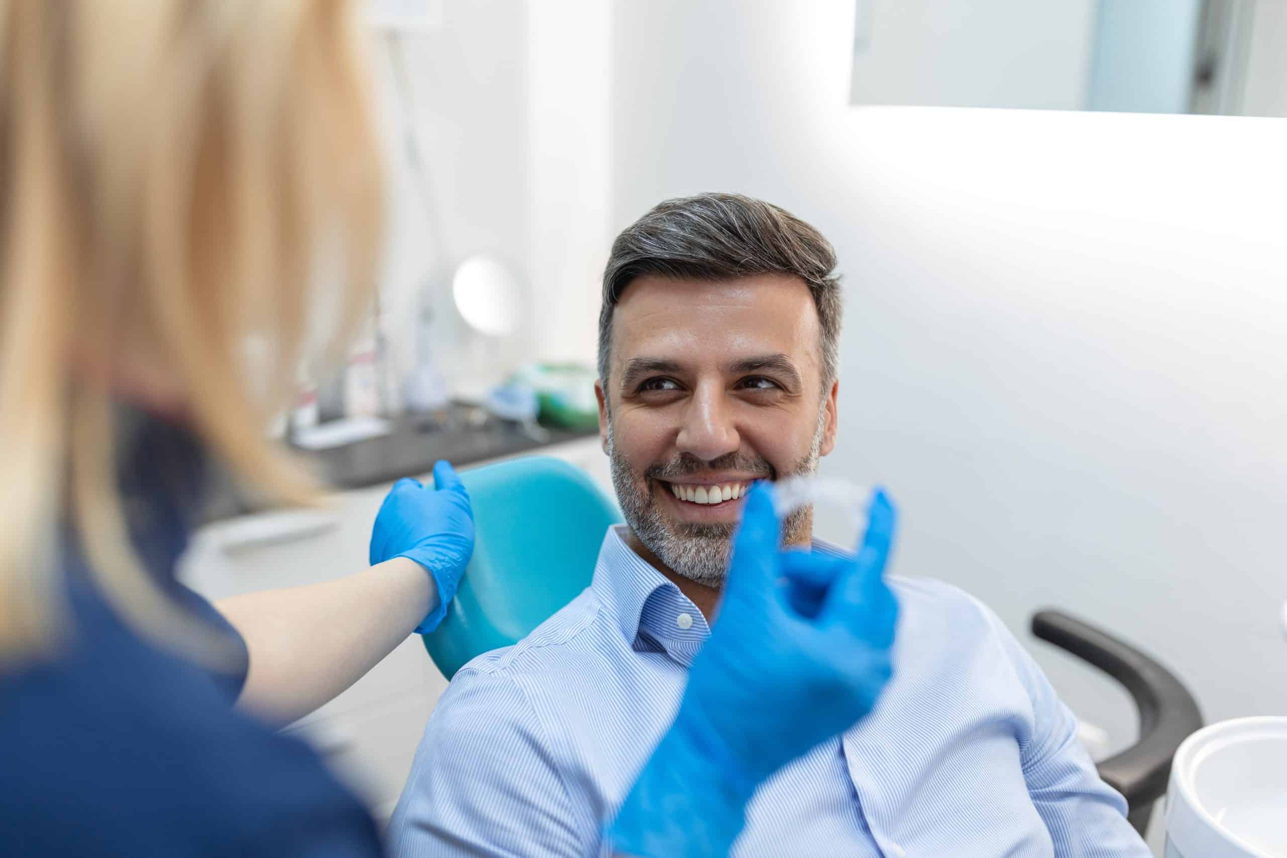 man looking at clear aligners